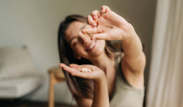 A Happy Woman Holding a Beauty Supplement